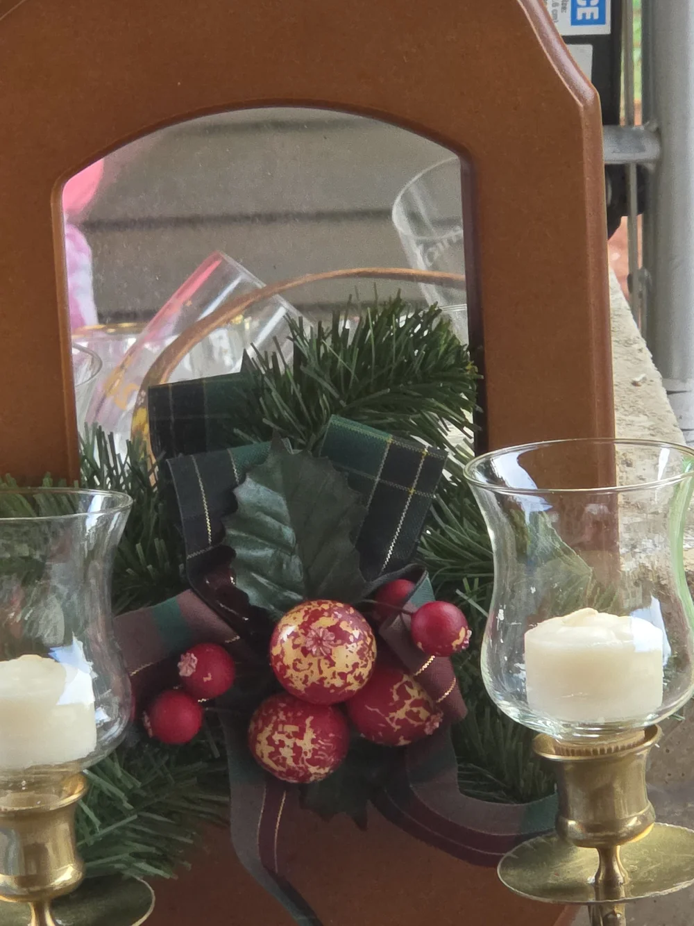Wall-Mounted Brown Mirror Candle Sconce with Holiday Greenery